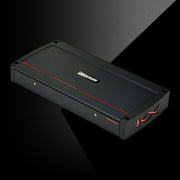 Angled view of KICKER KXA2400.1 amplifier with black housing, red accent line, and side KX logo.