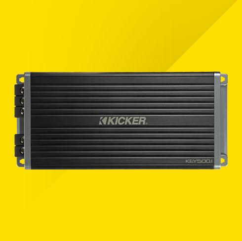 Top view of KICKER KEY500.1 compact black car amplifier with ribbed casing.