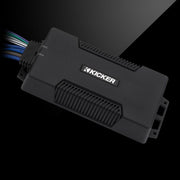 Angled view of KICKER PXA amplifier with rugged black housing and sealed wiring harness.