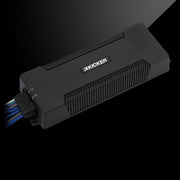 Angled top view of a KICKER PXA amplifier with extended low-profile design and sealed wiring.