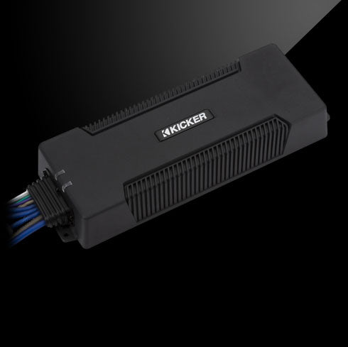 Angled top view of a KICKER PXA amplifier with extended low-profile design and sealed wiring.